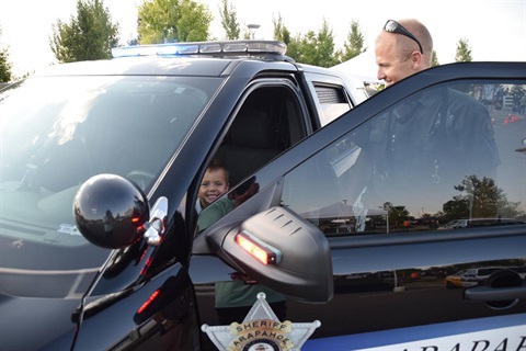 image of kid in police car