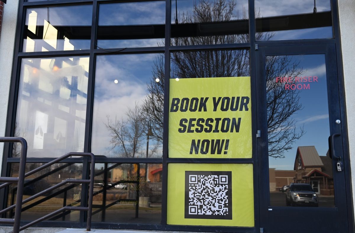 Window sign example - says book your session now with a QR code
