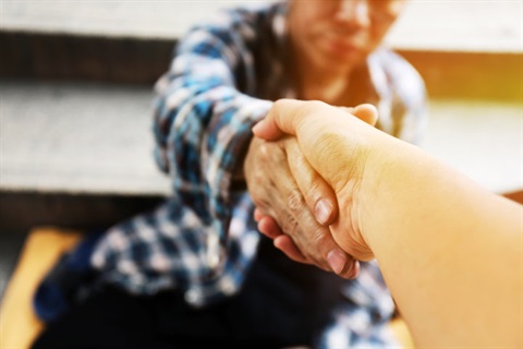 A hand reaching out to help another person